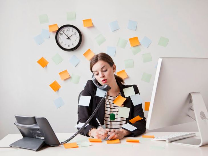 studio-shot-of-young-woman-working-in-office-covered-with-adhesive-notes-166274916-587056f75f9b584db3d3c8ef